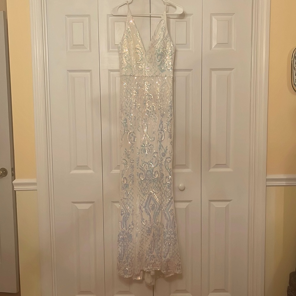 A white maxi dress embroidered with cool toned sequins.
